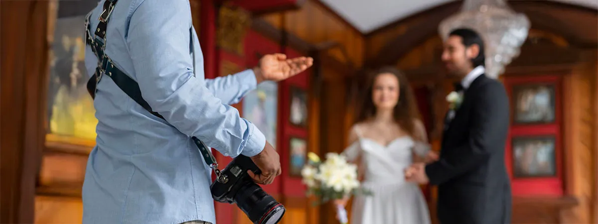Wedding photographer giving direction to the bride and groom